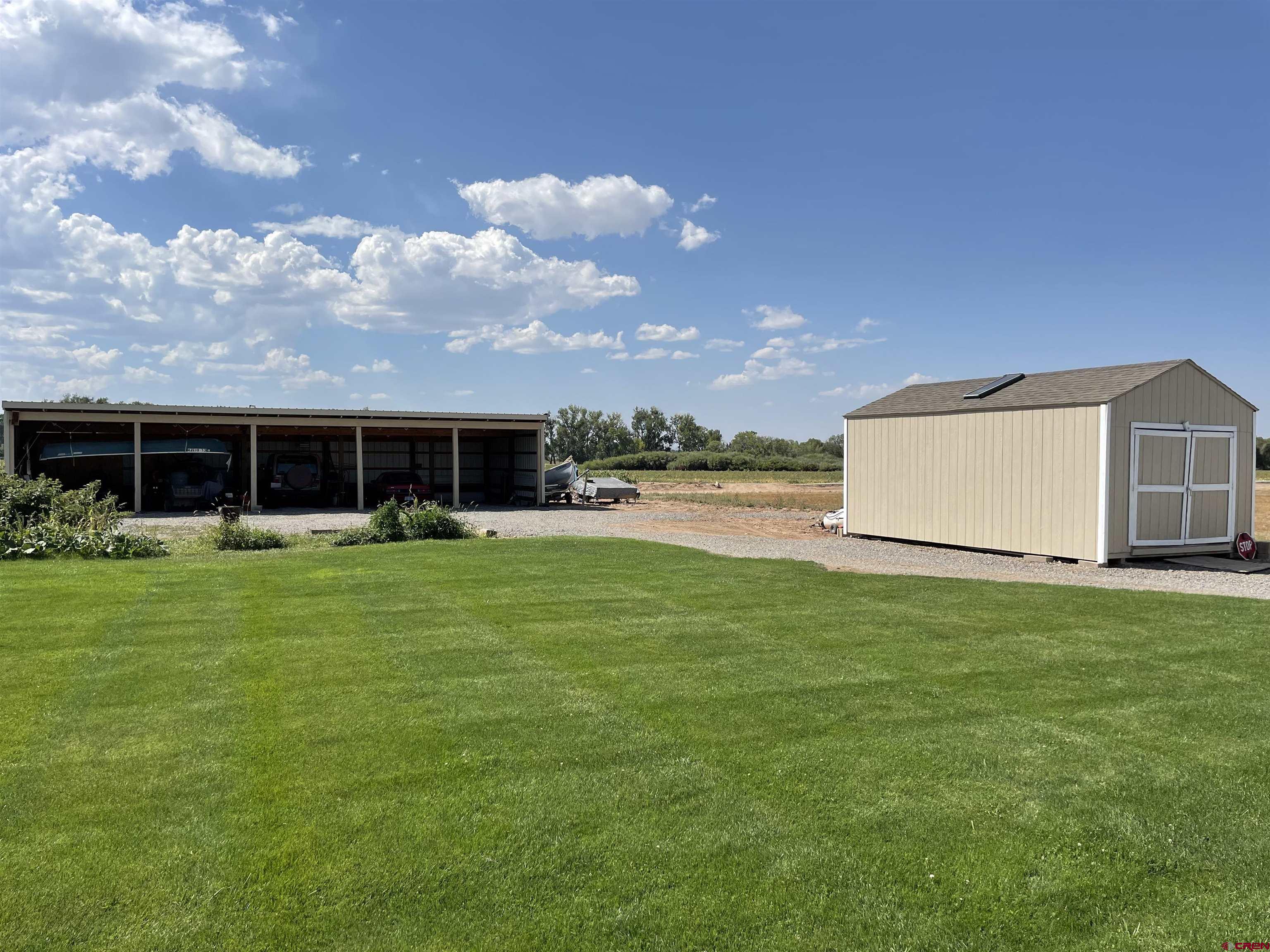 14755 6215th Road Montrose, CO 81403 - Photo 7 of 34 a front view of house with a garden