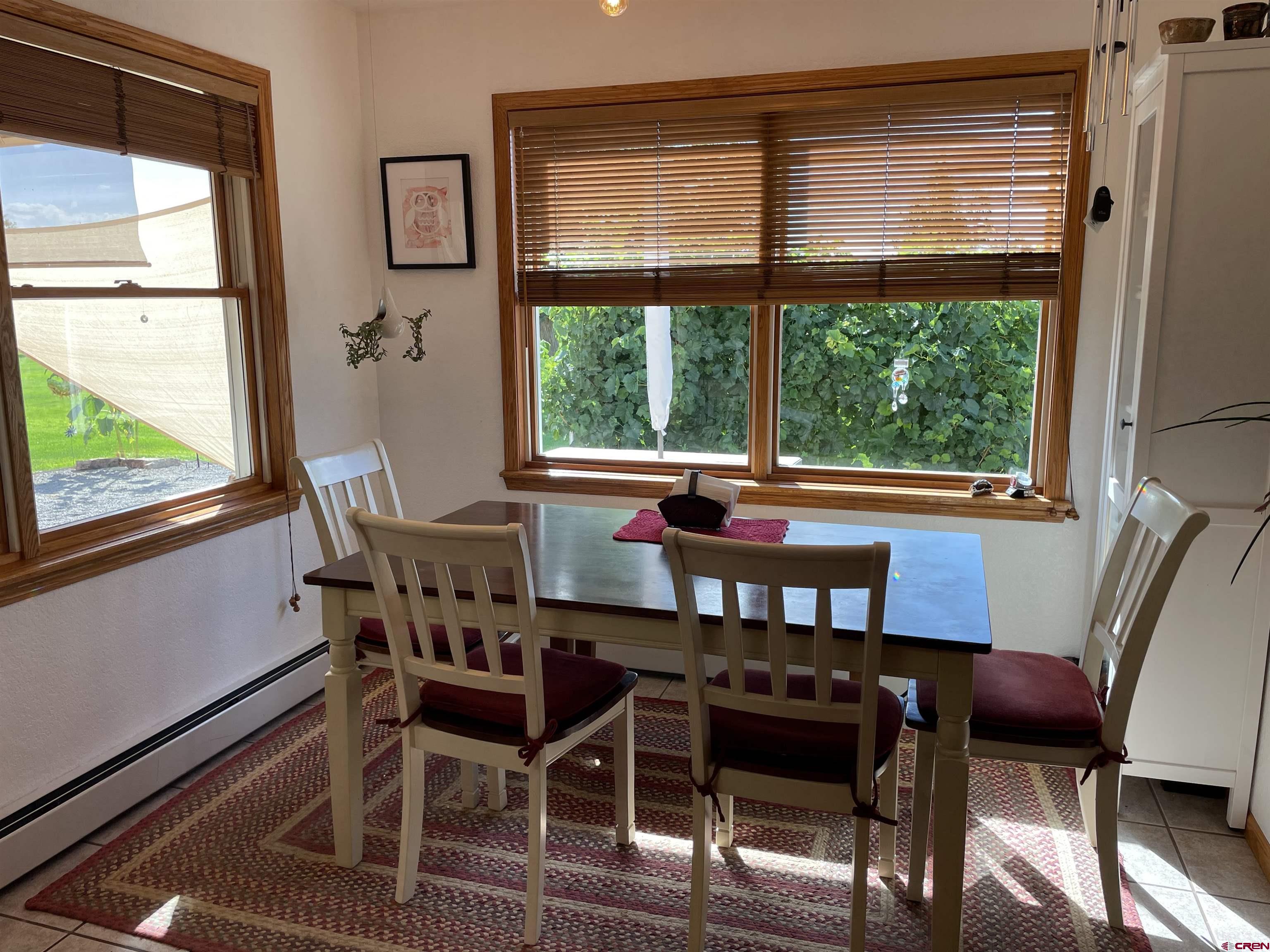 14755 6215th Road Montrose, CO 81403 - Photo 8 of 34 a view of a dining room with furniture window and outside view