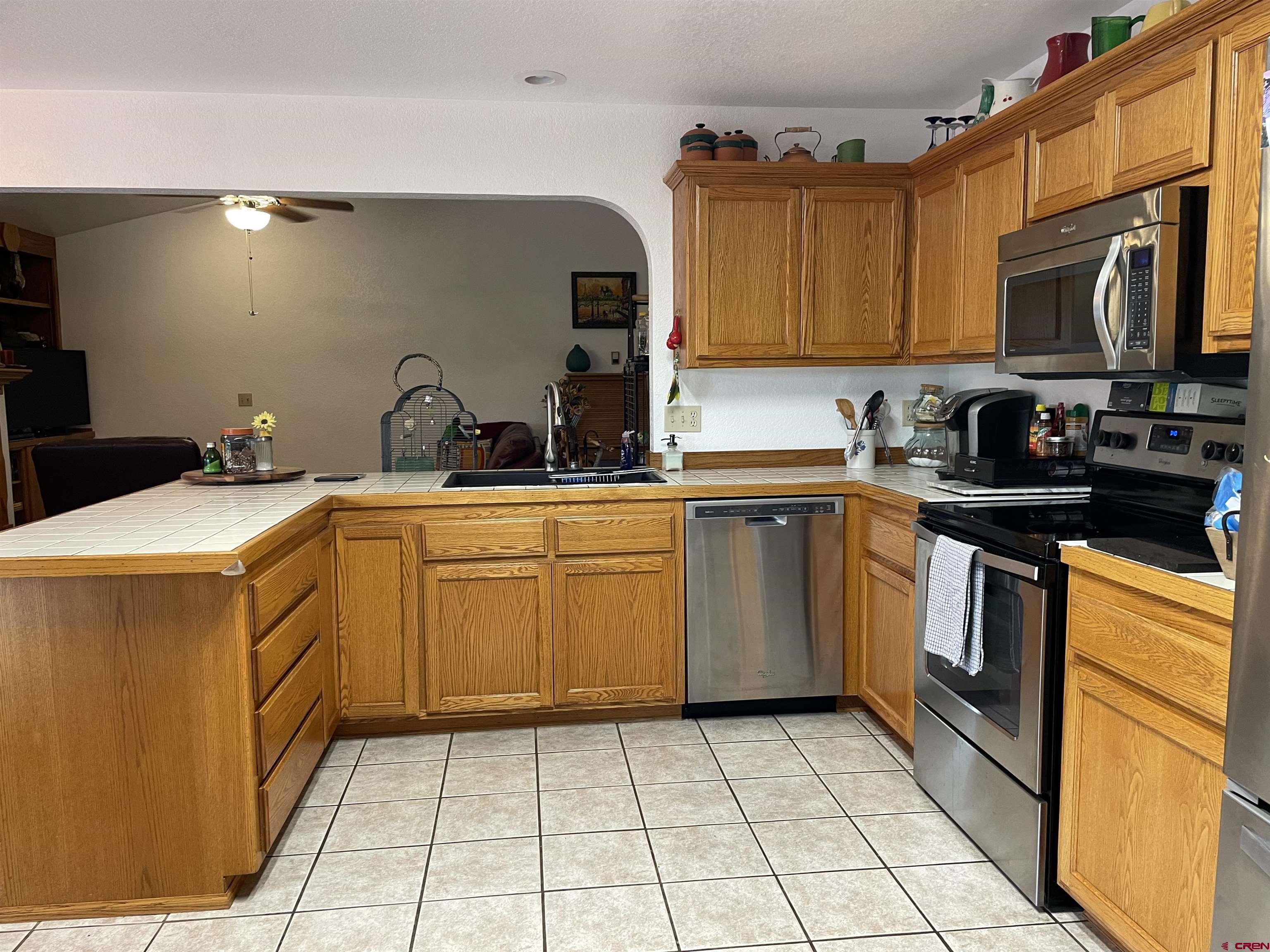 14755 6215th Road Montrose, CO 81403 - Photo 10 of 34 a kitchen with a sink a stove top oven and cabinets