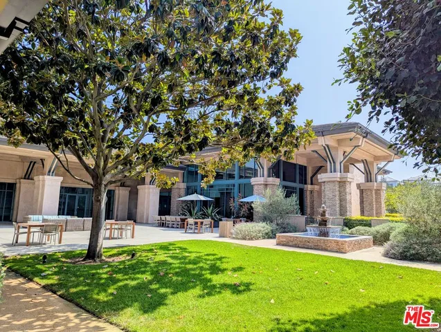 a front view of a building with a yard