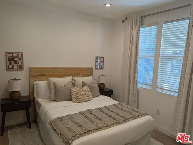 a bedroom with a bed and window