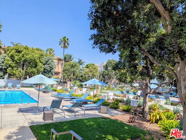 a view of a swimming pool and lounge chairs