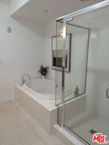 a white bath tub sitting next to a shower