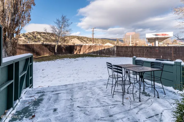 a view of a backyard with furniture and a tree