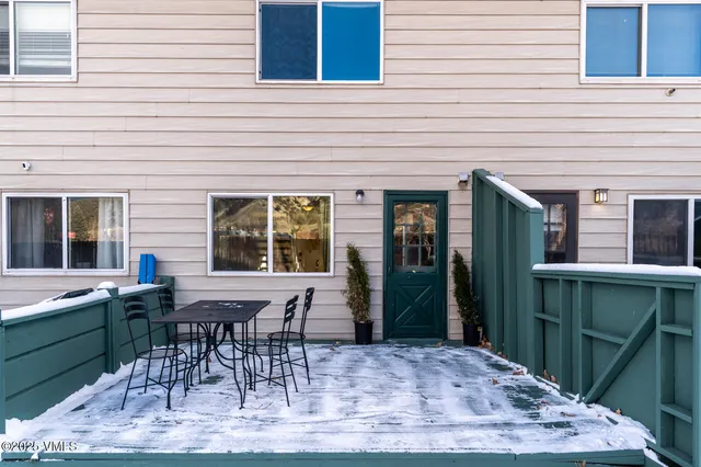 a view of a house with backyard and a chair