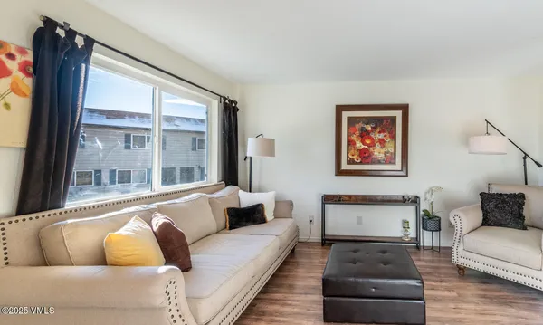 a living room with furniture and a large window