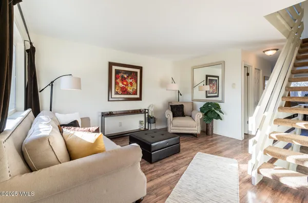 a living room with furniture and wooden floor