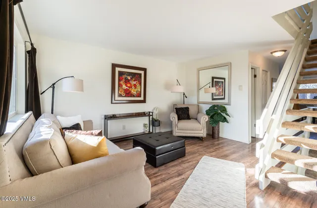 a living room with furniture and wooden floor