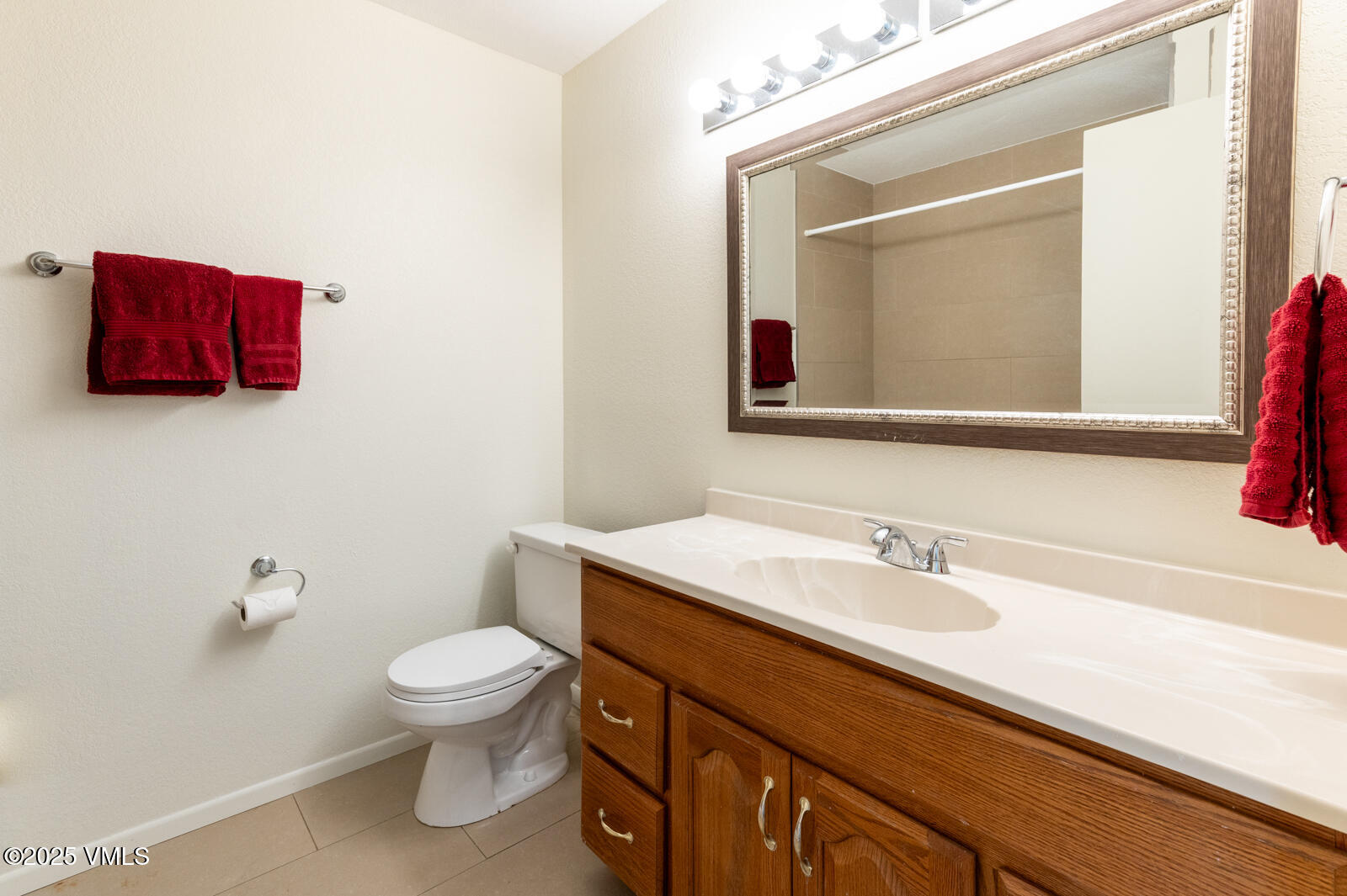 85 Chambers Avenue, Unit 10 Eagle, CO 81631 - Photo 33 of 37 a bathroom with a sink vanity mirror and toilet