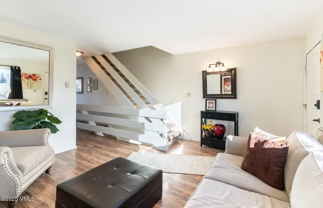 a living room with furniture and wooden floor