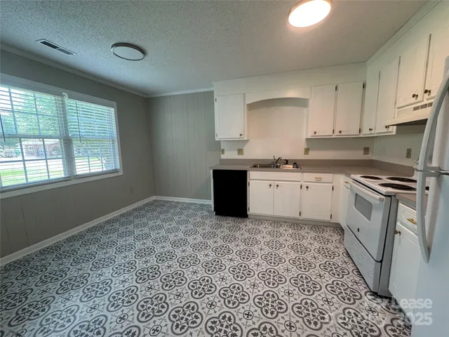 a kitchen with a sink stove and cabinets