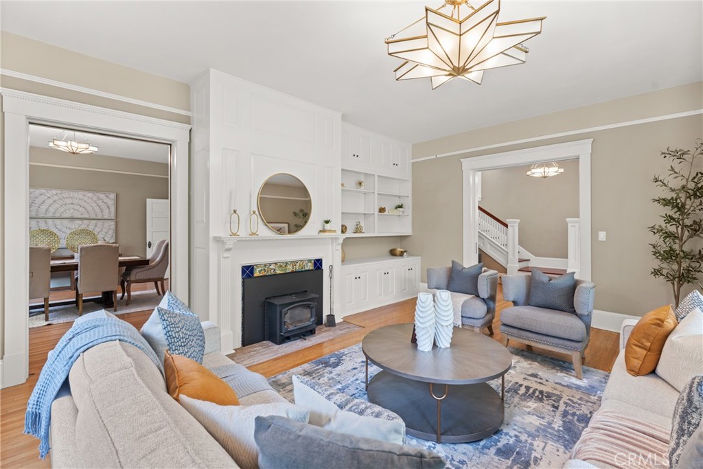 16 Campbell Avenue Redlands, CA 92373 - Photo 12 of 57 a living room with furniture a fireplace and a large mirror