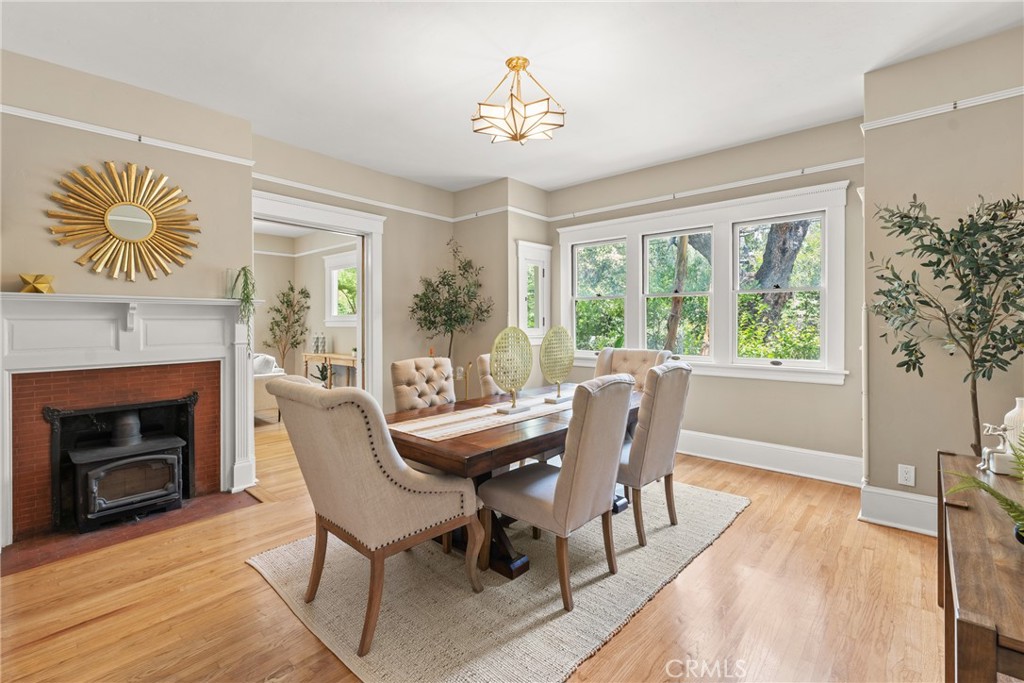 16 Campbell Avenue Redlands, CA 92373 - Photo 15 of 57 a dining room with furniture a fireplace and wooden floor