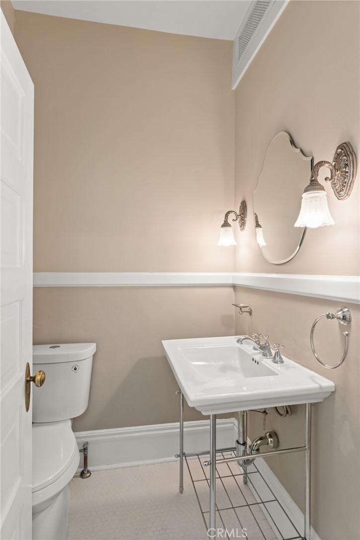 16 Campbell Avenue Redlands, CA 92373 - Photo 20 of 57 a bathroom with a sink a toilet and a mirror