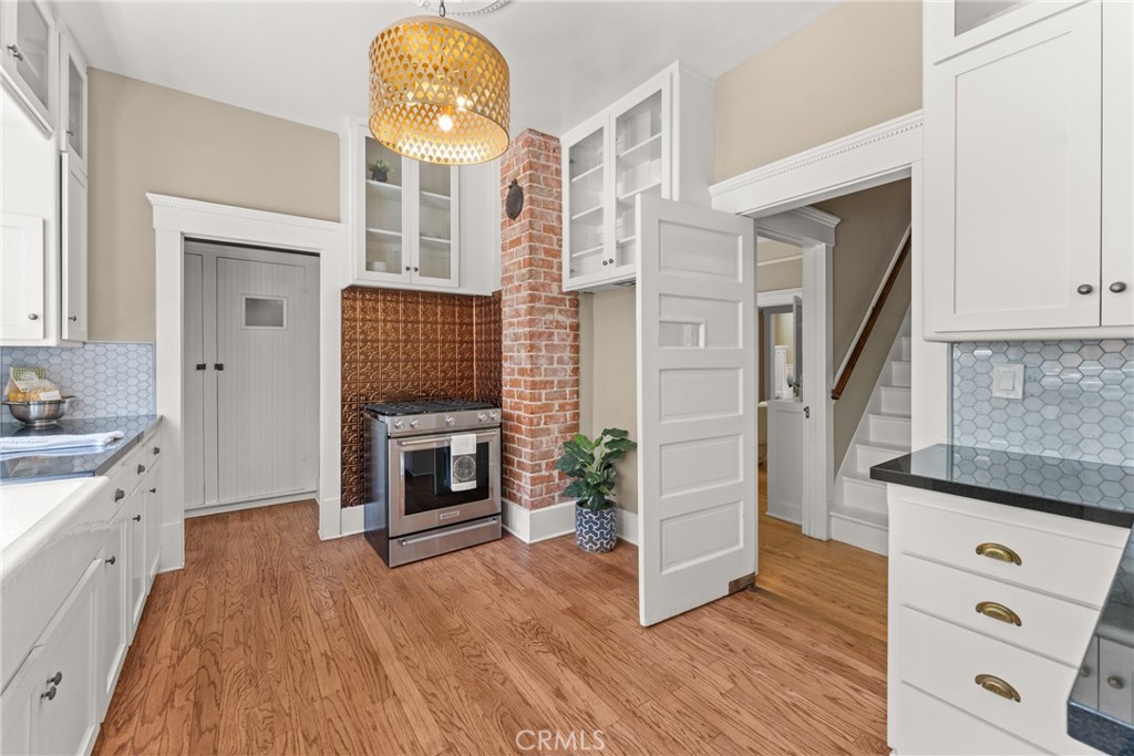 16 Campbell Avenue Redlands, CA 92373 - Photo 22 of 57 a view of a kitchen cabinets and wooden floor