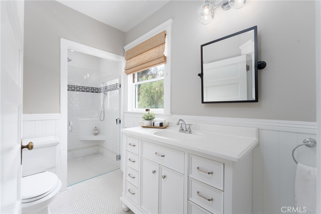 16 Campbell Avenue Redlands, CA 92373 - Photo 36 of 57 a bathroom with a double vanity sink toilet mirror and shower