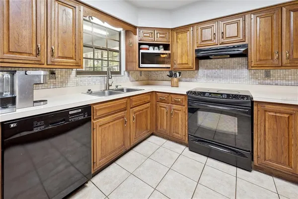 a kitchen with stainless steel appliances granite countertop a stove sink and cabinets