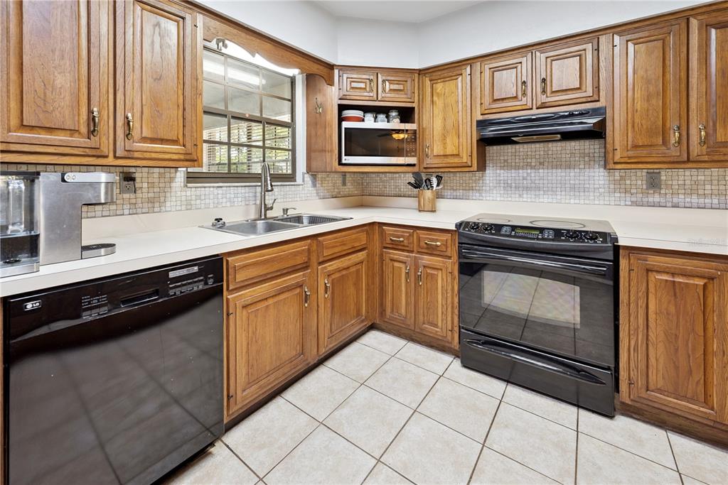 5098 Southwest 47th Loop Lake Butler, FL 32054 - Photo 14 of 34 a kitchen with stainless steel appliances granite countertop a stove sink and cabinets