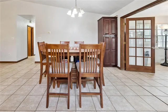 a view of a dining room with furniture and chandelier