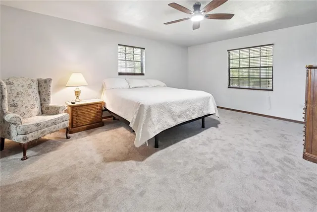 a spacious bedroom with a bed and window