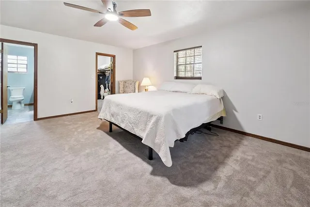 a spacious bedroom with a bed and window