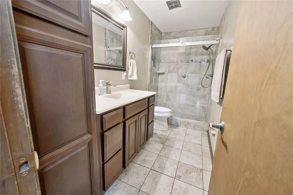 a bathroom with a double vanity sink toilet and shower