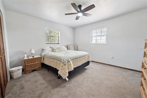 a spacious bedroom with a bed and a window