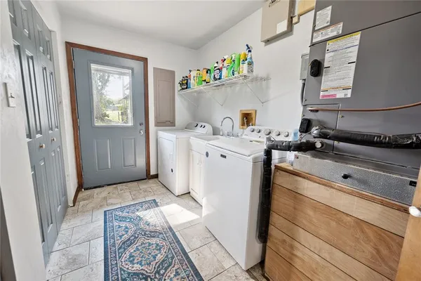 a utility room with sink dryer and washer