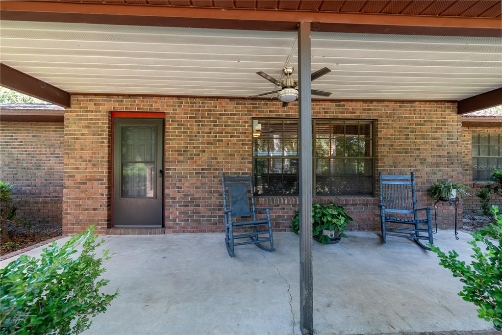 5098 Southwest 47th Loop Lake Butler, FL 32054 - Photo 3 of 34 a view of a patio with table and chairs potted plants and a table and chair