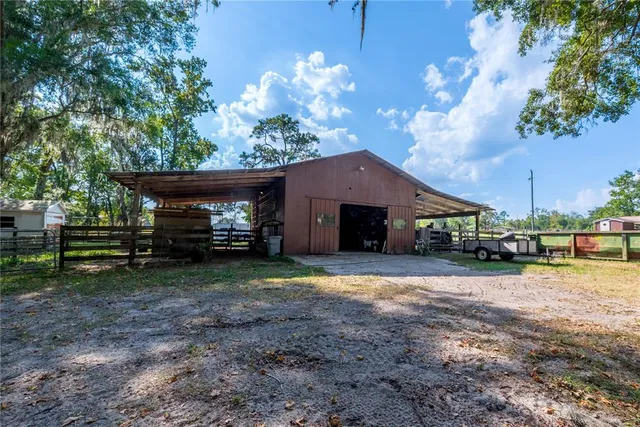 a view of a house with backyard and a tree
