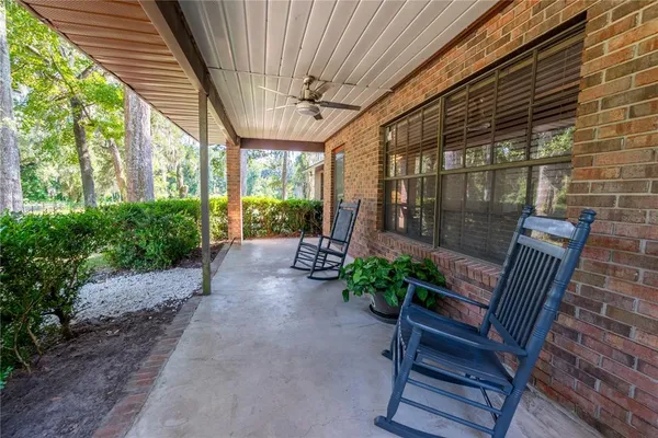 a view of a porch with furniture and garden