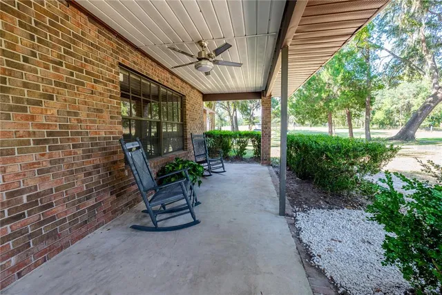 a view of a patio with a table chairs and a potted plant