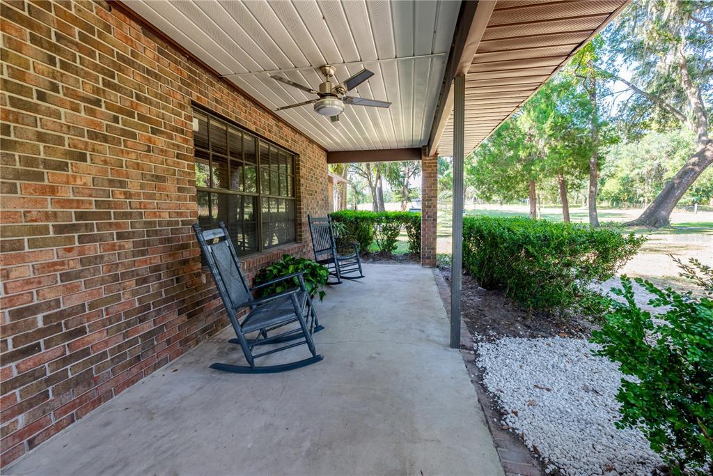 5098 Southwest 47th Loop Lake Butler, FL 32054 - Photo 5 of 34 a view of a patio with a table chairs and a potted plant