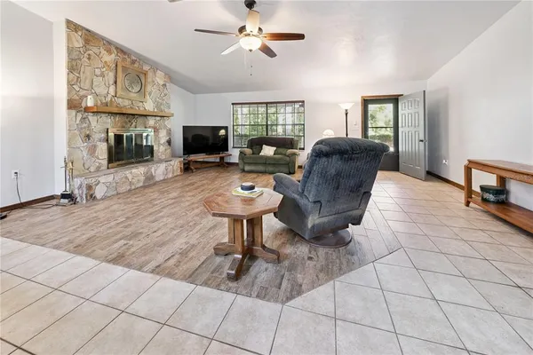 a living room with furniture a flat screen tv and a table
