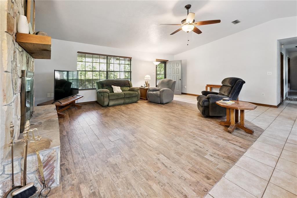 5098 Southwest 47th Loop Lake Butler, FL 32054 - Photo 10 of 34 a living room with furniture and a flat screen tv