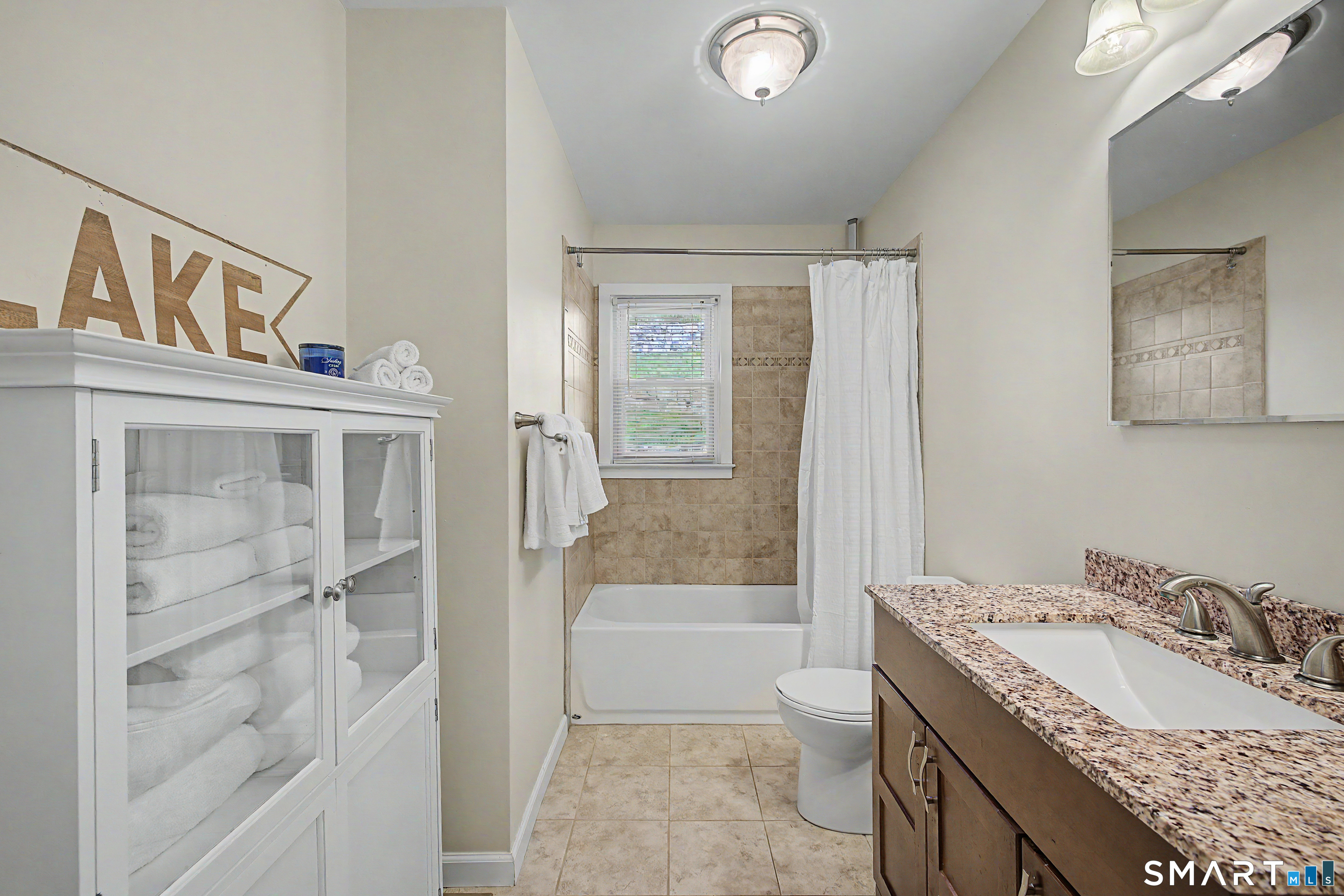 11 Candlewood Springs Road New Milford, CT 06776 - Photo 17 of 35 a bathroom with a granite countertop sink a toilet and shower