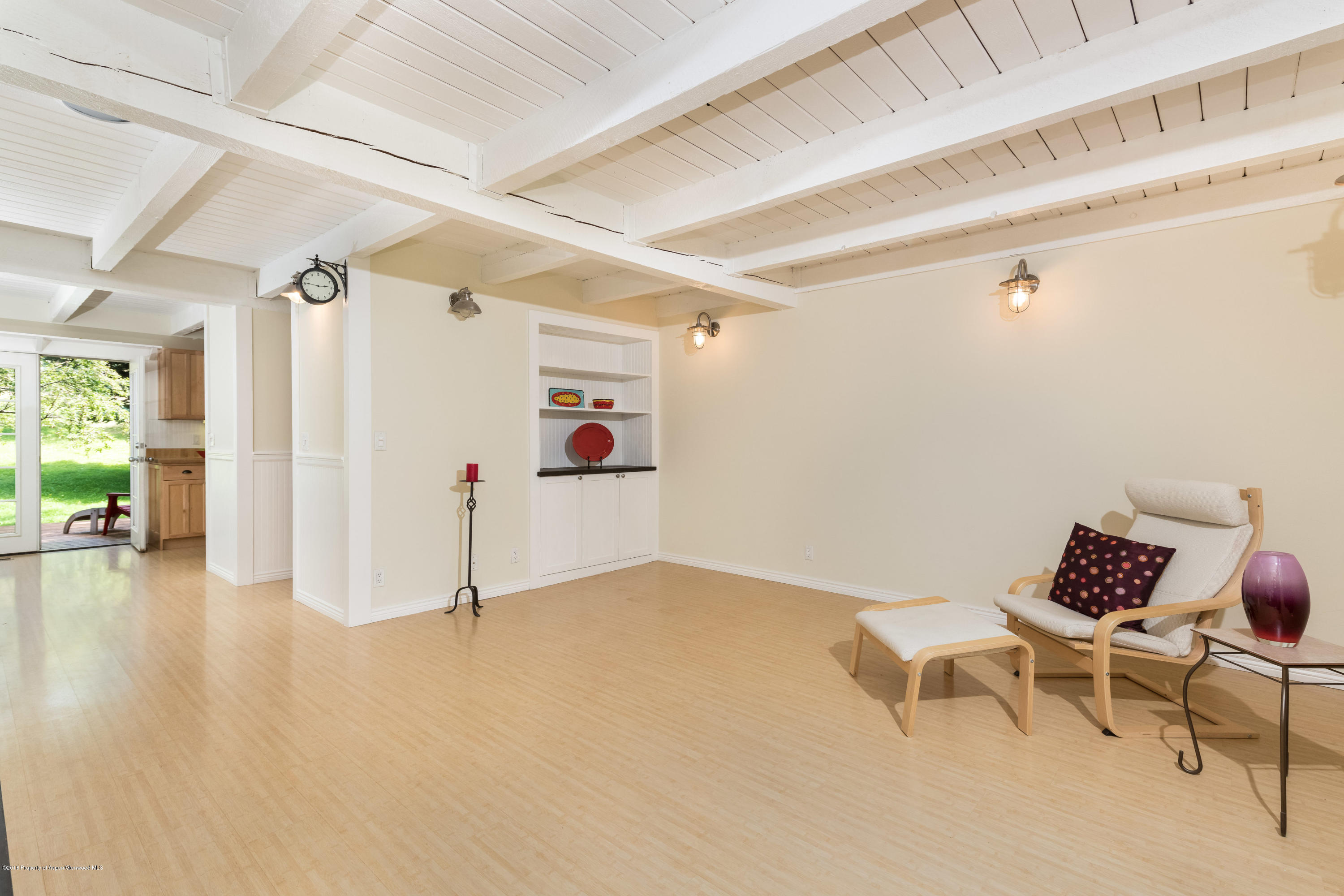 331 Holland Hills Road, Unit 6 Basalt, CO 81621 - Photo 6 of 27 a view of a livingroom with wooden floor and a dining table