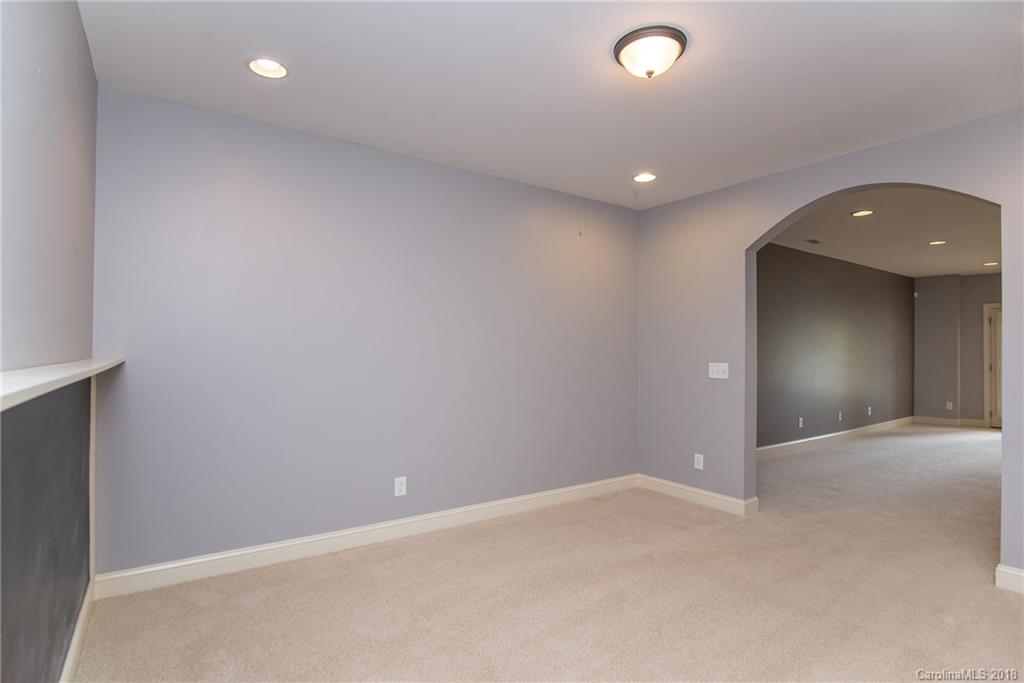 944 Gardenia Street Fort Mill, SC 29708 - Photo 25 of 35 an empty room with a chandelier fan and window