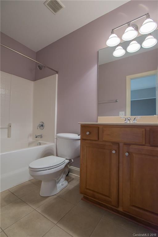 944 Gardenia Street Fort Mill, SC 29708 - Photo 27 of 35 a bathroom with a sink a toilet a mirror a bathtub and shower