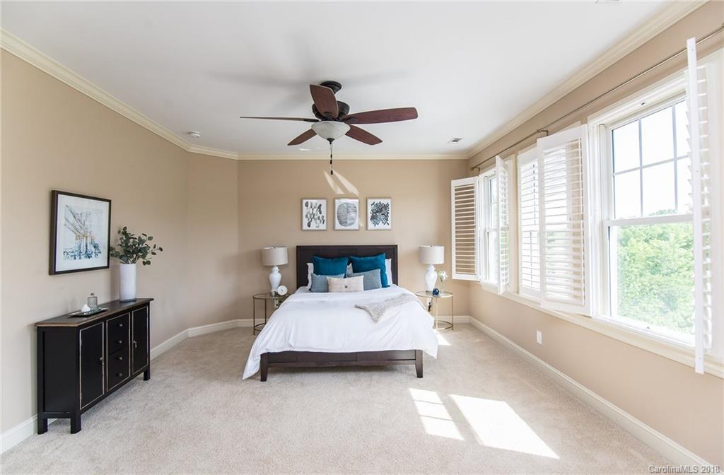 944 Gardenia Street Fort Mill, SC 29708 - Photo 31 of 35 a bed room with a bed and a chandelier