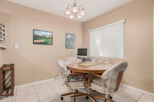 a view of a dining room with furniture and chandelier