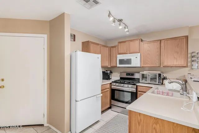 a kitchen with a refrigerator a sink and a stove