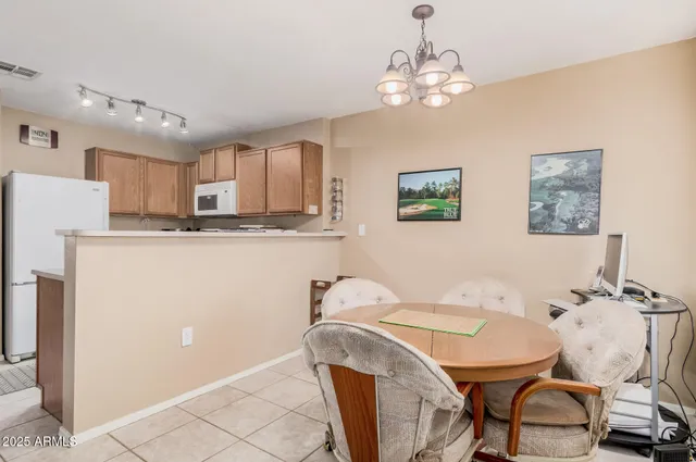 a dining room with table and chairs