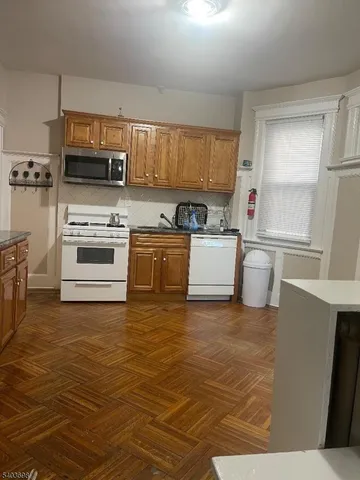 a kitchen with stainless steel appliances a stove a sink and a refrigerator