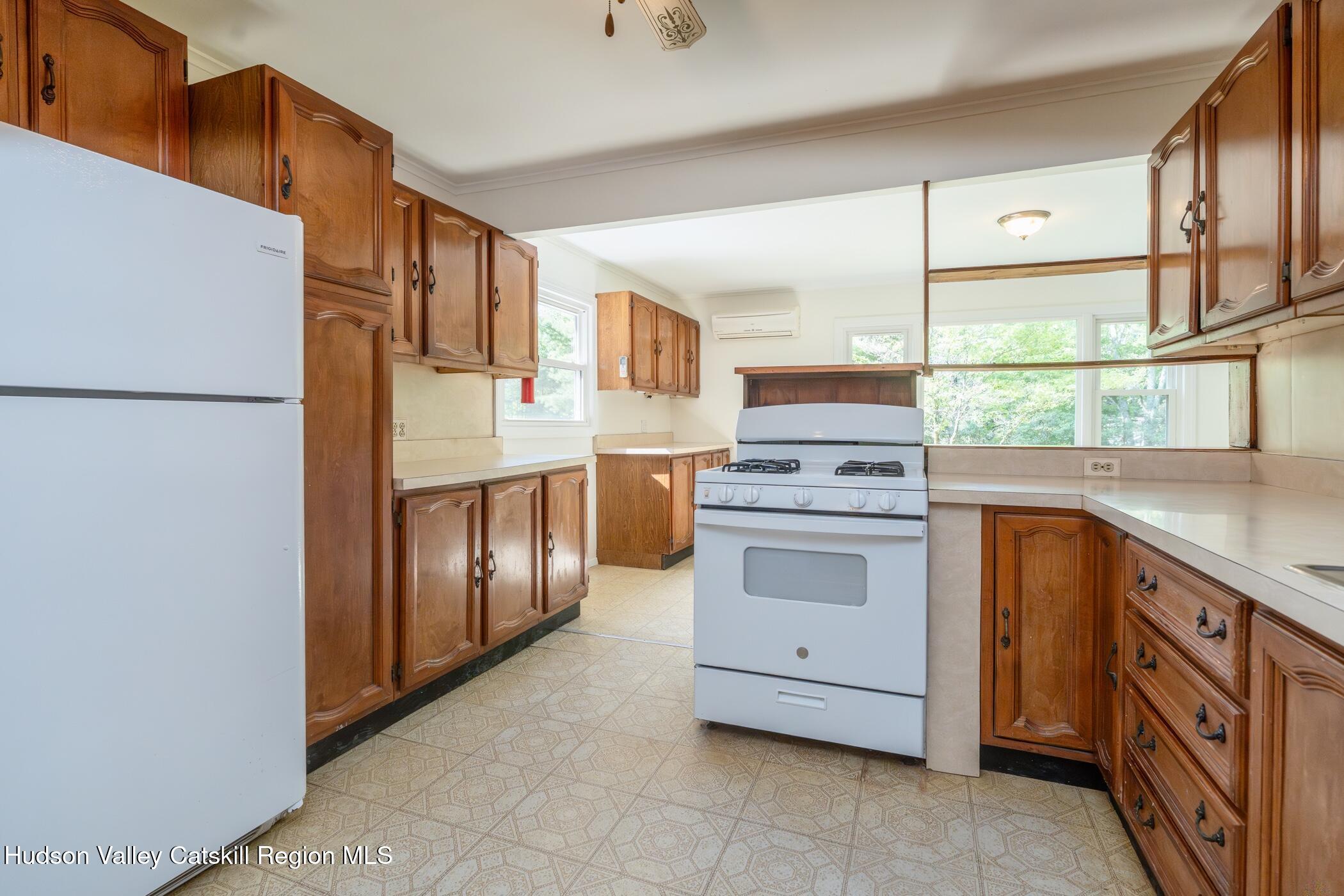 4533 Atwood Road Stone Ridge, NY 12484 - Photo 12 of 63 a kitchen with stainless steel appliances granite countertop a stove a sink and a refrigerator