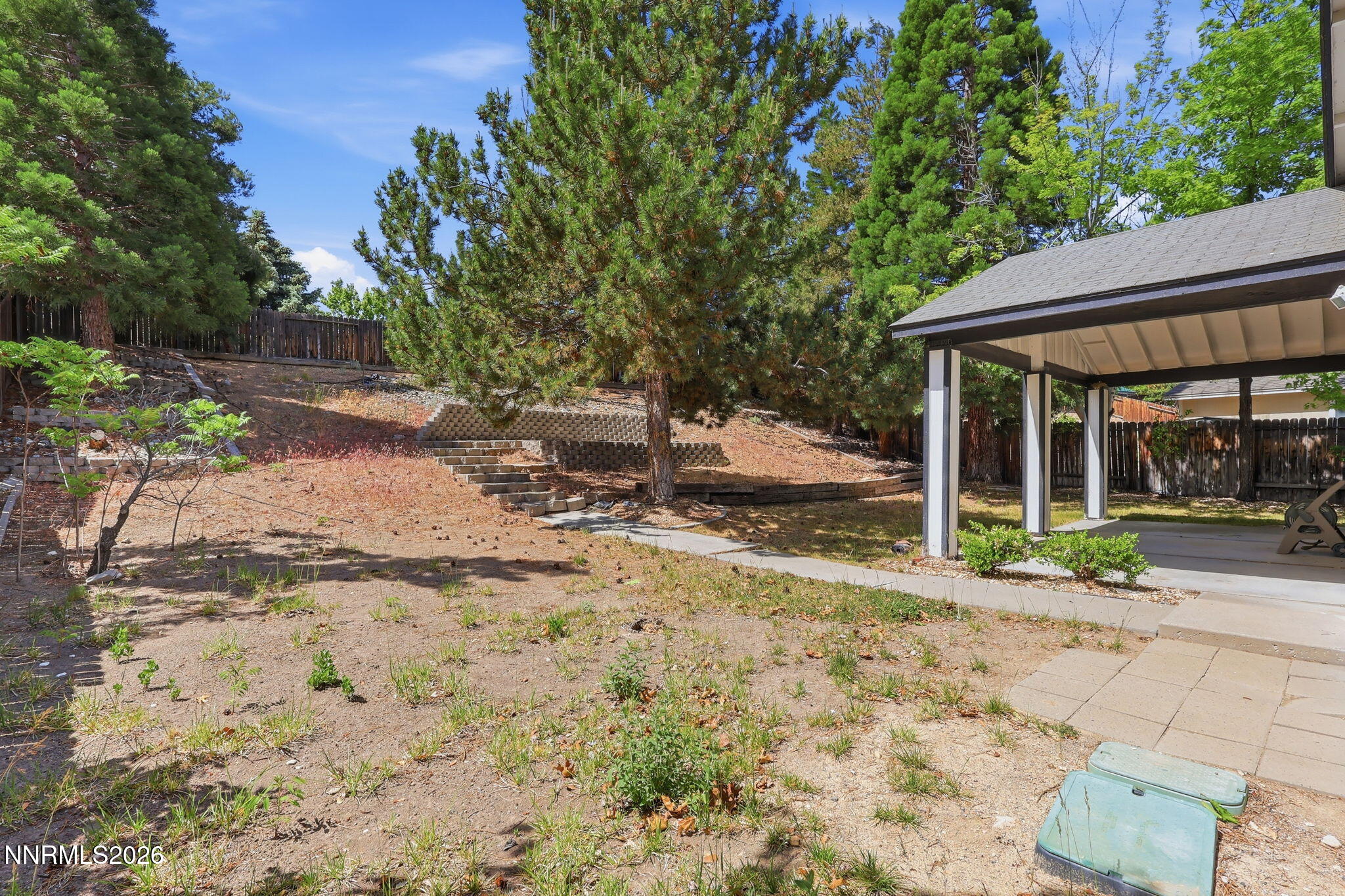 6840 Viscaya Court Reno, NV 89523 - Photo 6 of 25 a backyard of a house with barbeque oven table and chairs