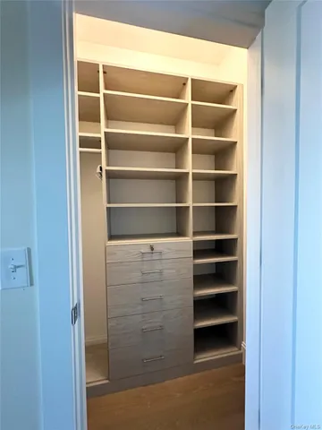 a view of walk in closet with empty racks