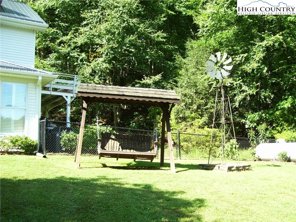 874 Long Branch Road Lansing, NC 28643 - Photo 5 of 32 a view of a backyard with a garden and deck