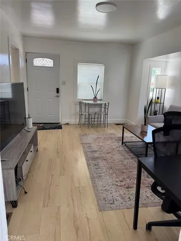 a view of a livingroom with furniture and a flat screen tv