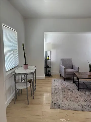 a living room with furniture and a rug